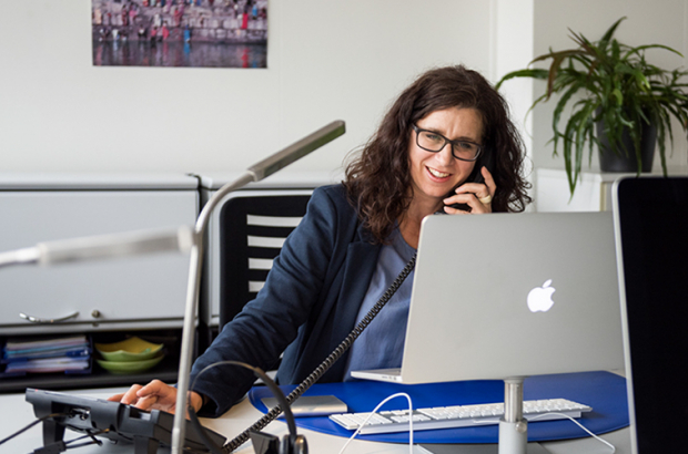 counsellor behind the computer on the phone