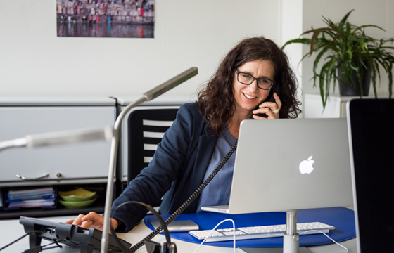 counsellor behind the laptop on the phone